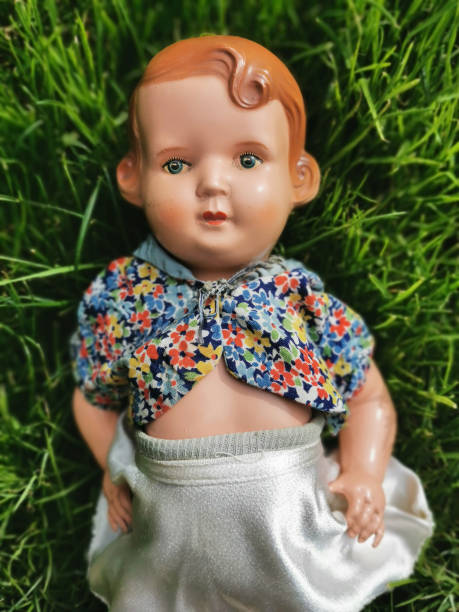 istock old baby doll in the green grass 2178331215