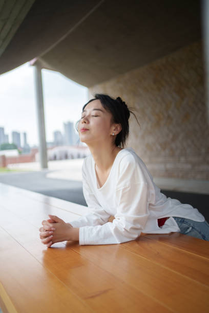 istock Asian woman relaxing with eyes closed 2178331438