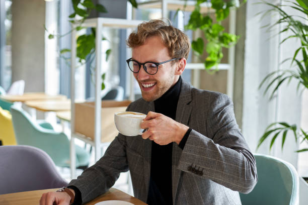 istock Happy businessman drinking coffee during break in cafe 2178331645