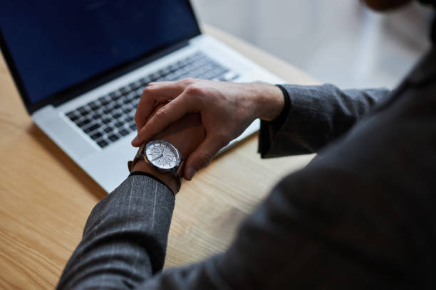 istock Businessman checking time on wristwatch in office 2178331981
