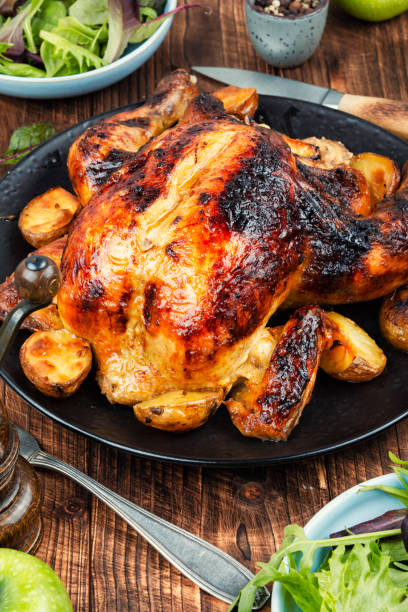 istock Roasted, baked chicken with potatoes and apples. 2178334414