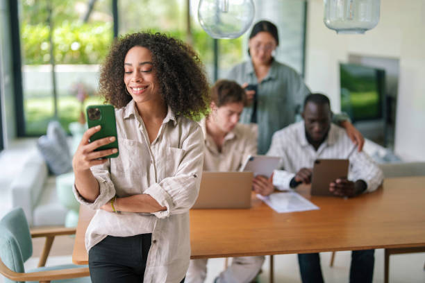 istock Smiling African American Businesswoman Texting in Office Environment 2178335152
