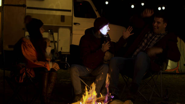 istock Bearded man telling a scary story to his friends around camp fire 2178335371