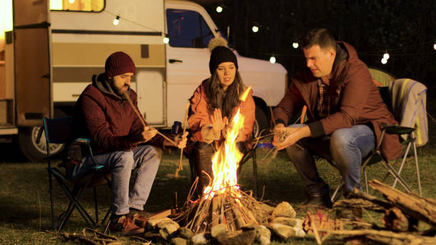 istock Girl warming up her hands while her friend making the fire stronger 2178335555