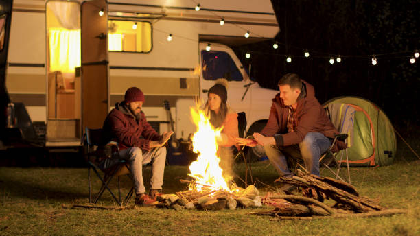 istock Friends warming up their hands during a cold night at camp fire 2178335725