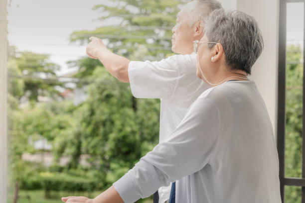 istock Two elderly individuals enjoy a light-hearted conversation and laughter on a balcony, sharing a peaceful and joyful moment in a relaxed outdoor setting, highlighting friendship and companionship. 2178335897
