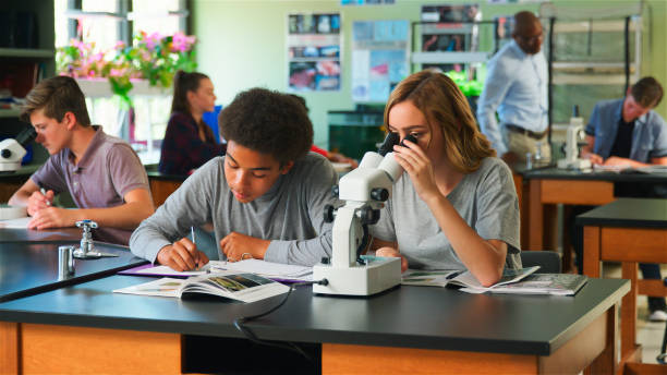 istock Male And Female High School Students Using Microscope In Biology Class 2178336088