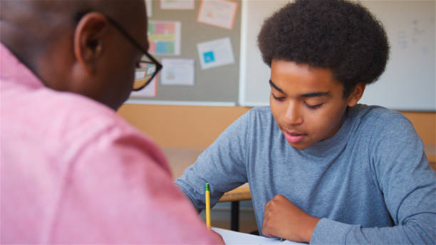 istock High School Tutor Giving Male Student One To One Tuition At Desk 2178336511