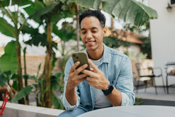 istock Man enjoying phone time in lush outdoor setting 2178336575