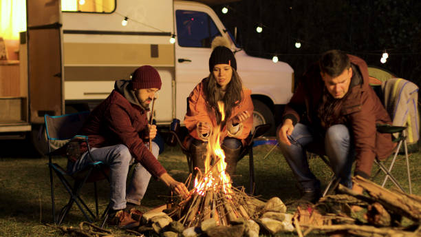istock Girl warming up her hands while her friend making the fire stronger 2178336693
