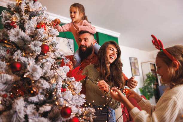 istock Family having fun decorating Christmas tree at home 2178338054