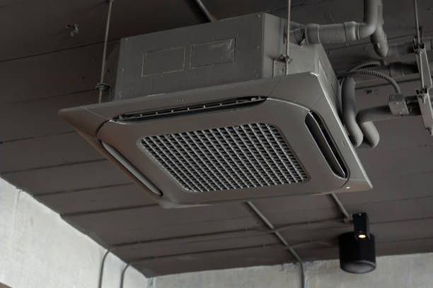 istock A black air conditioner is hanging from the ceiling. cassette type air conditioner. 2178338819