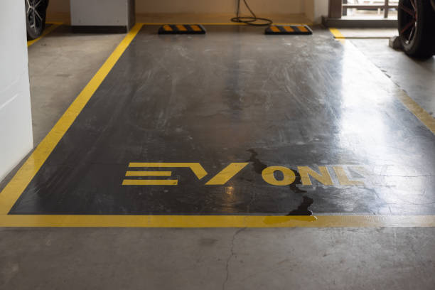 istock A EV car parking lot with a yellow line and a black line 2178339305