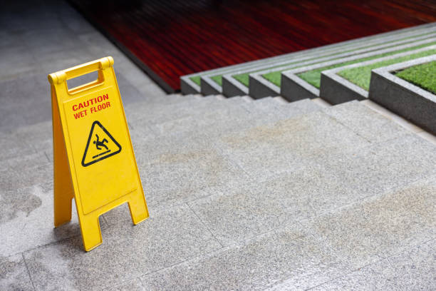 istock A yellow caution sign is on the ground in front of a staircase 2178339332