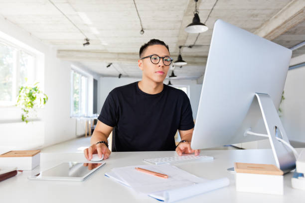 Handsome asian man working in the creative workplace