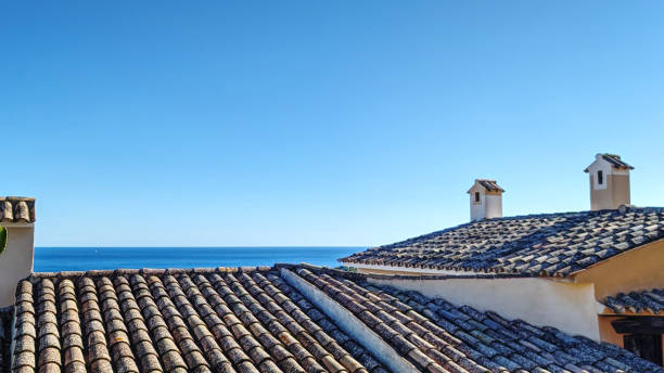 Panoramic sea view from the cliff of the bay of Mediterranean sea and rooftops of typical houses at the idyllic small town of Cala Fornells on Majorca island, Spain, Balearic Islands. Panoramic sea view from the cliff of the bay of Mediterranean sea and rooftops of typical houses at the idyllic small town of Cala Fornells on Majorca island, Spain, Balearic Islands. seaside views of cala fornells mallorca stock pictures, royalty-free photos & images