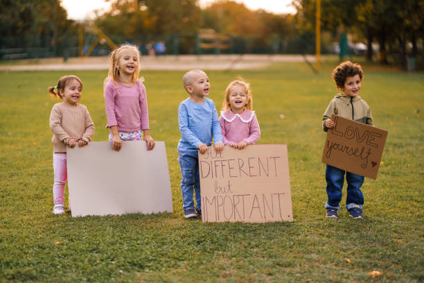 istock Children hold signs with messages in nature 2178341576
