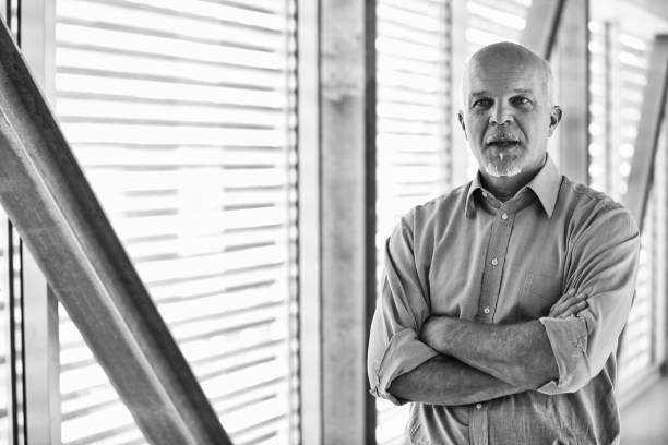 istock Senior it manager standing with arms crossed in modern office bu 2178341596
