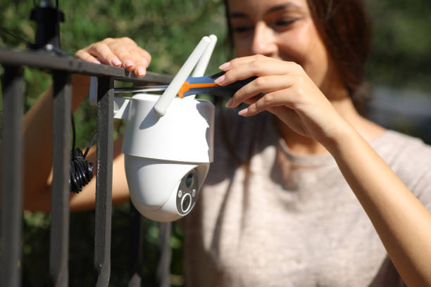 istock Woman installing wifi security camera in a garden 2178341974