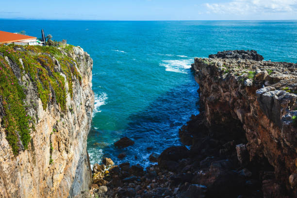 istock A dramatic coastal scene with steep cliffs covered in greenery, leading down to the deep blue ocean, with waves crashing against the rocky shore, creating a breathtaking seascape 2178342121