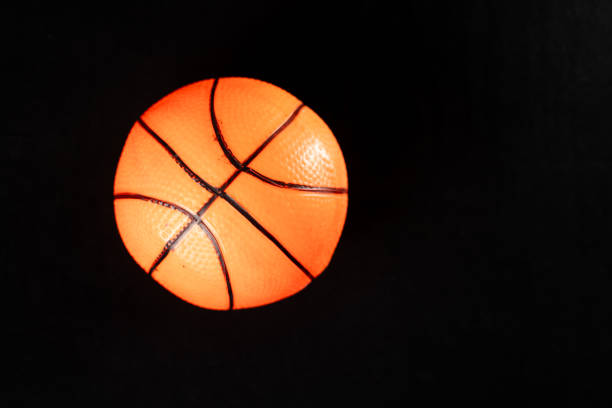 istock Orange Basketball on Black Surface 2178342358