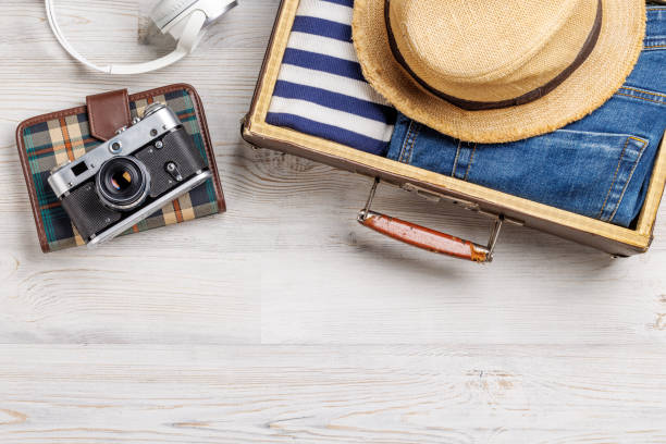 istock A travel bag with clothes, sun hat, flip flops, and a camera 2178342993