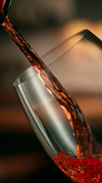 istock Close-up of red wine pouring into glass 2178343616