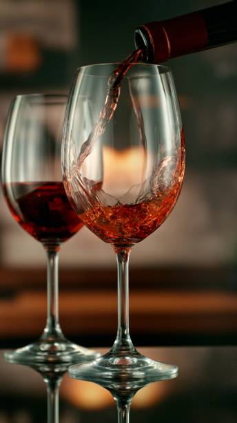 istock Close-up of red wine pouring into glass 2178343633