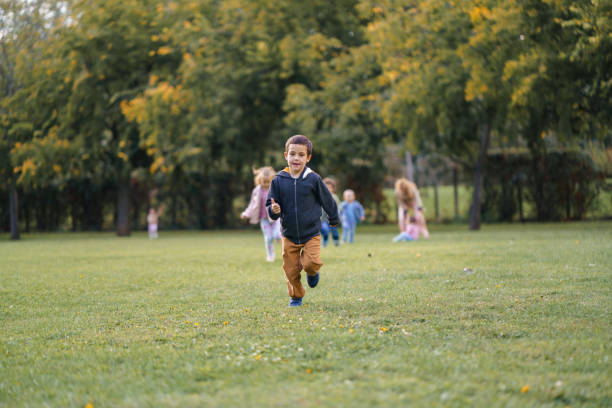 istock Boy running on a meadow whit his friends 2178346779
