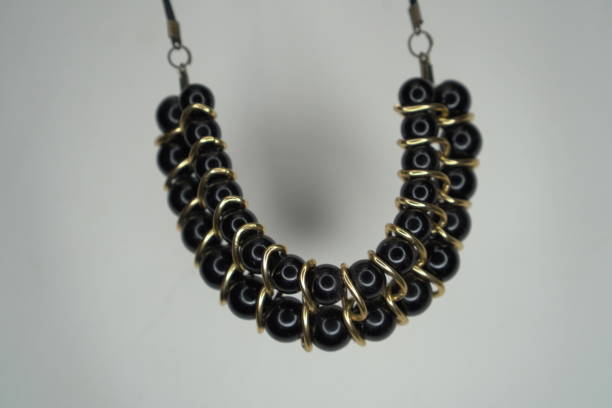 Bold and beautiful, this statement necklace is a must-have for fashion-forward individuals. The double strand of black beads and gold accents create a striking visual impact.