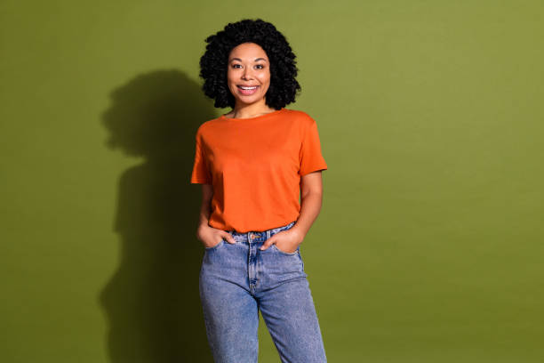 istock Photo portrait of lovely young lady hands pockets posing dressed stylish orange garment isolated on khaki color background 2178347318