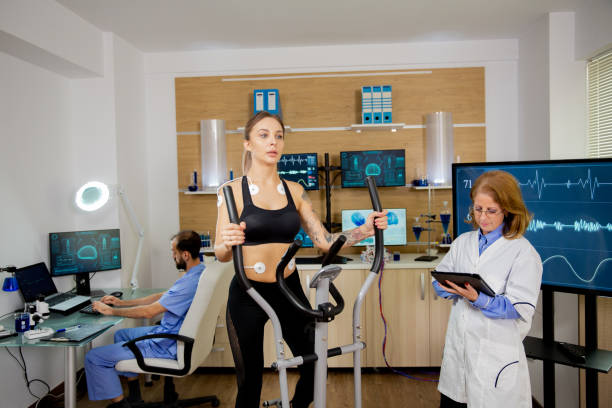 istock Female athlete who runs tests on the stepper and the doctor follows her evolution and makes notes on the tablet 2178348403