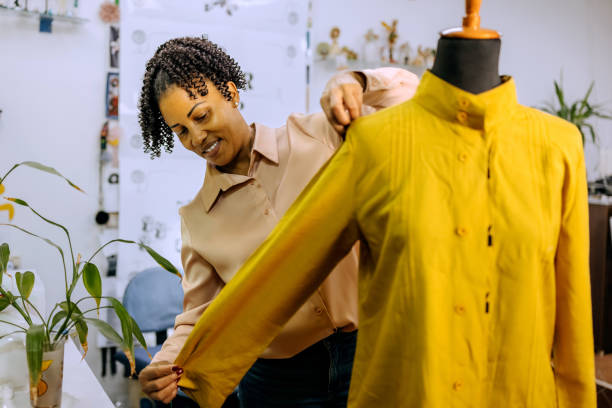 istock Smiling female tailor working at her small clothing store 2178349694