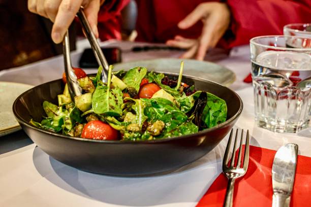 istock Fresh mixed salad being served at a dining table 2178350400
