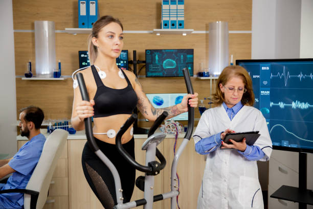 istock Female athlete who runs tests on the stepper and the doctor follows on her tablet evolution 2178350861
