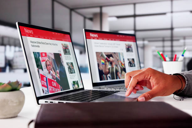 istock Watching Online News Article On Mobile Phone And Laptop 2178352062