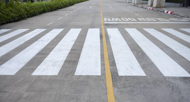 A road with a white line down the middle and a yellow line on the side