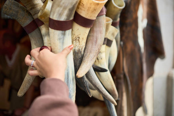 istock Hand Holding Rustic Drinking Horns at Market Stall 2178356870