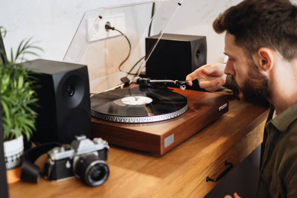 istock Handsome Man Starting a Vinyl Record on the Player to Enjoy Music 2178358465