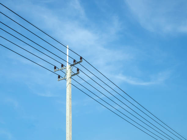 istock Reinforced concrete pillar with high-voltage wires against a clear blue sky. Transmission of electricity by wires over long distances. Electricity power lines against a clear sky. 2178363781