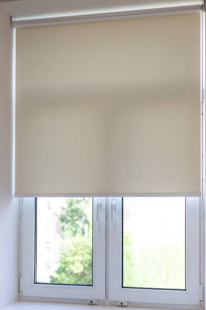 istock Natural light filtering through partially closed roller blind on a sunny afternoon in a quiet room 2178365395