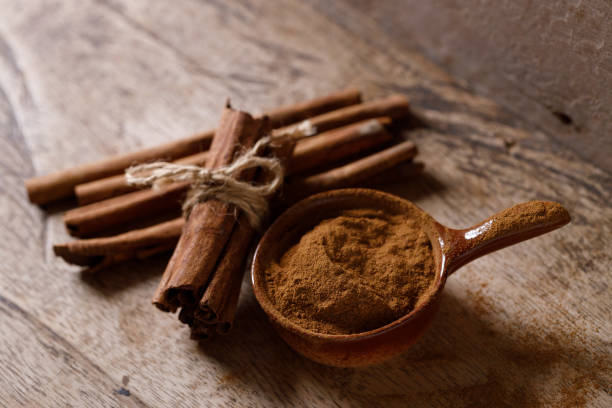 istock Aromatic cinnamon sticks and powder on wooden table. 2178365541