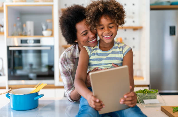 istock African american mother and daughter with tablet pc computer doing homework together at home 2178366393