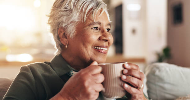 istock Senior woman, home and thinking with coffee for peace, quiet and comfortable couch in retirement. Female person, nostalgia and contemplating with cappuccino for calm, hot chocolate and mindfulness 2178366697