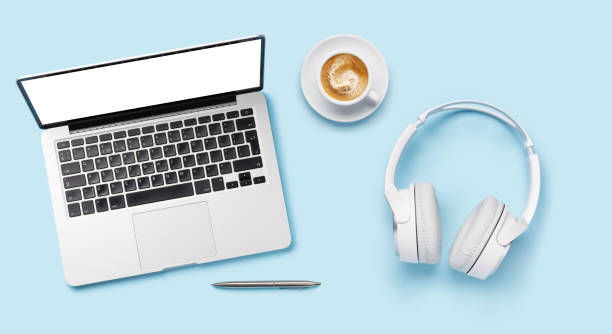 istock Laptop, headphones, and coffee cup arranged on a blue background 2178368670