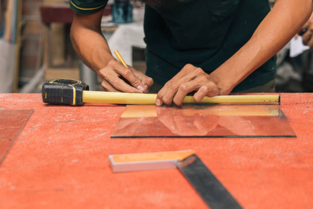 istock A person measures a piece of glass 2178368712