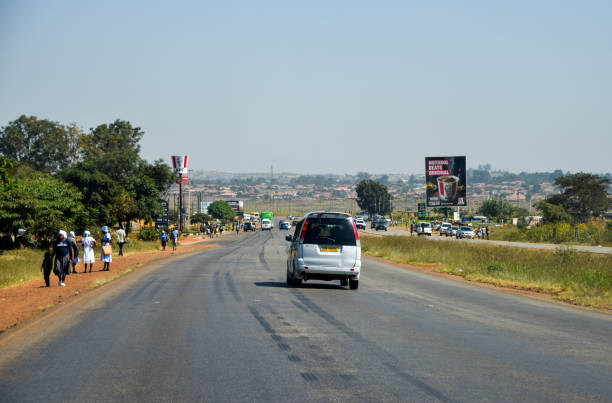 Harare, Zimbabwe - May 5 2024: people and cars on a wide road outside Harare.