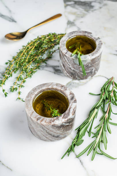 istock Flavoring: extra virgin olive oil with thyme and rosemary. Top view. White background 2178369449