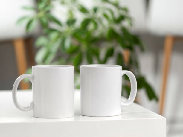 istock Mockup of a white tea cup or coffee mug on a white table in a Scandinavian style kitchen 2178370516