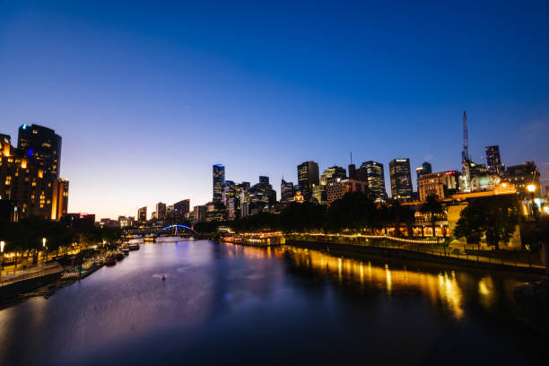 MELBOURNE, AUSTRALIA - OCTOBER 10, 2024: Melbourne skyline from Princes Bridge in Southbank along the Yarra River at dusk in Victoria, Australia